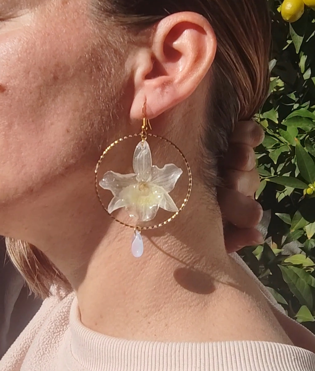 Pendientes con Mini Orquídeas Dendrobium Reales en Resina – Aro Dorado y Lágrimas de Cristal Iridiscente – Joyería Floral Hecha a Mano